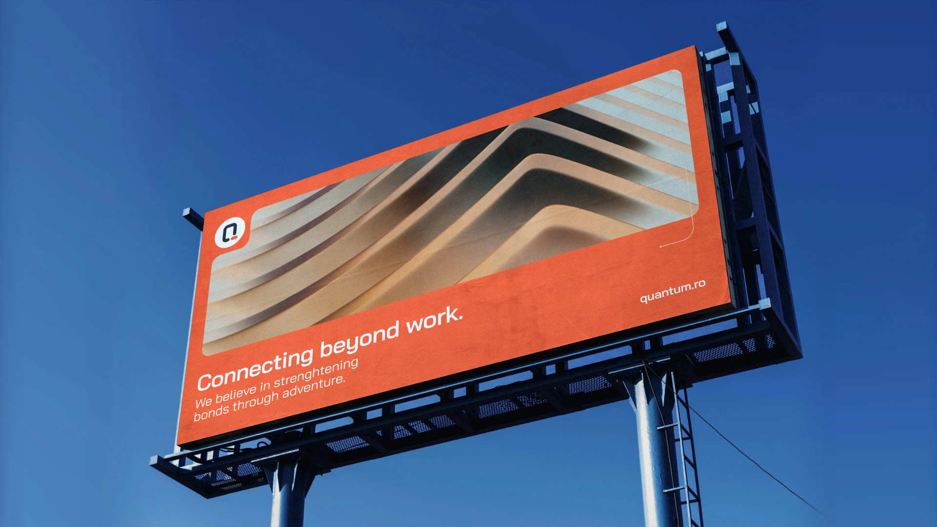 Quantum Soft billboard mockup displaying "Connecting beyond work" slogan against blue sky