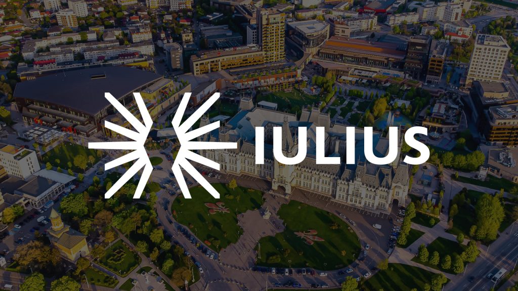 White IULIUS logo over aerial view of Palas Iasi mixed-use development and Palace of Culture